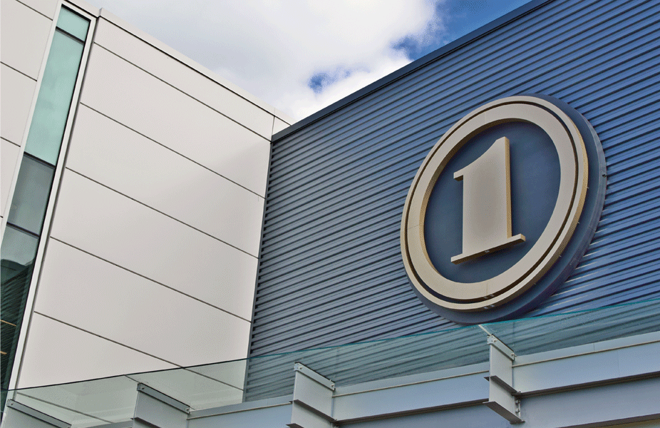 Image of the First National Bank logo prominently displayed on the exterior of a building.