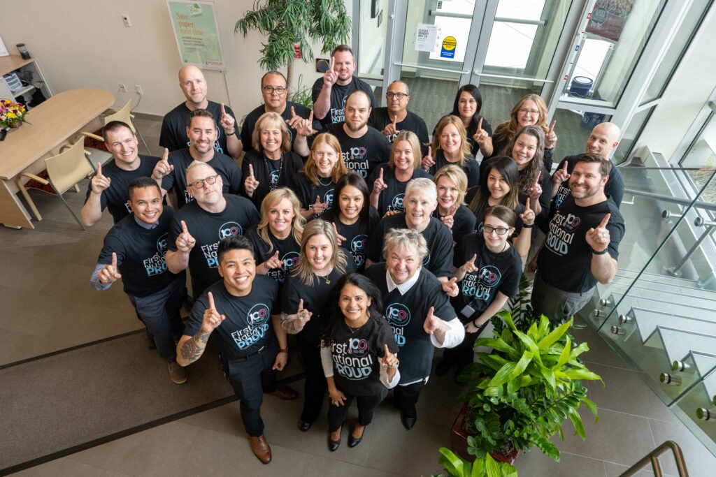 Team photo of staff holding up 1