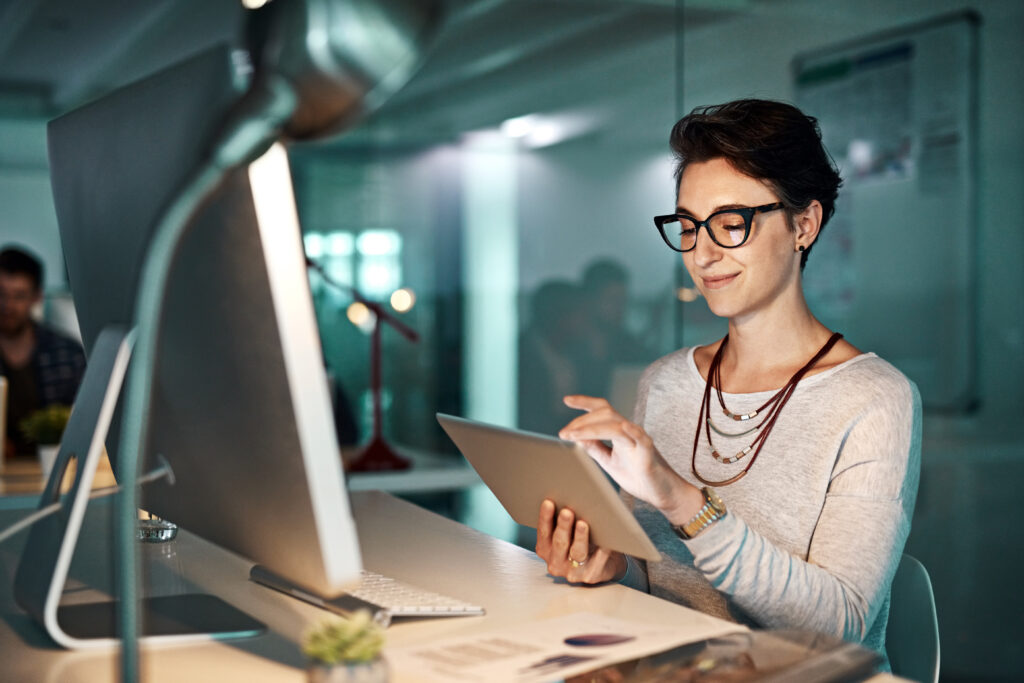 A photo of a young businesswoman working late at the office