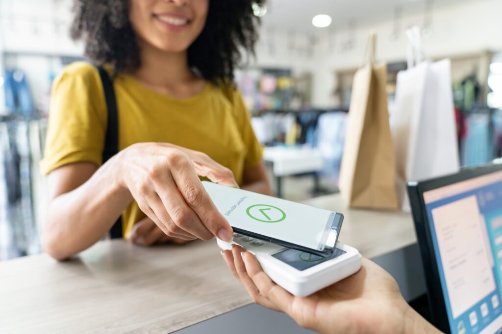 A woman utilizing her mobile phone to process a payment.